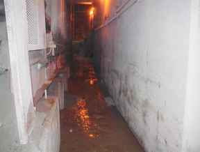 underground walkway beside a conveyor belt that is cleaned after an IVAC unit was used to pump out the materials