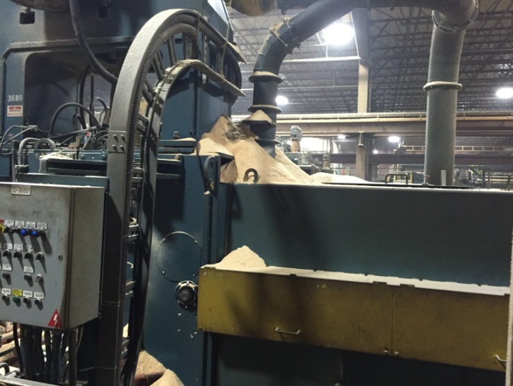 inside sawmill warehouse with woodchips on equipment