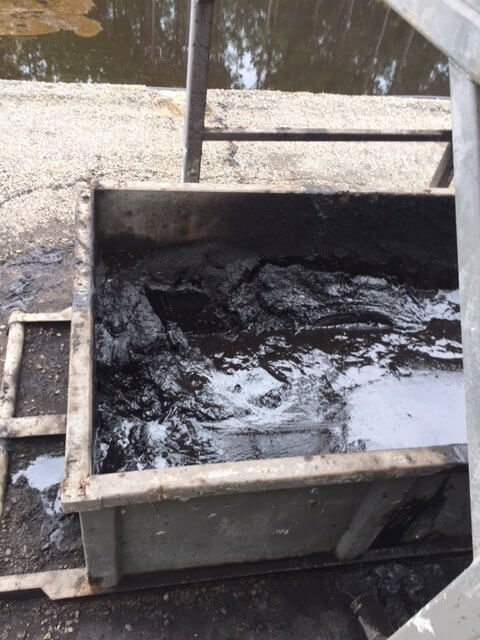 tank full of oil sludge to be pumped with vac system